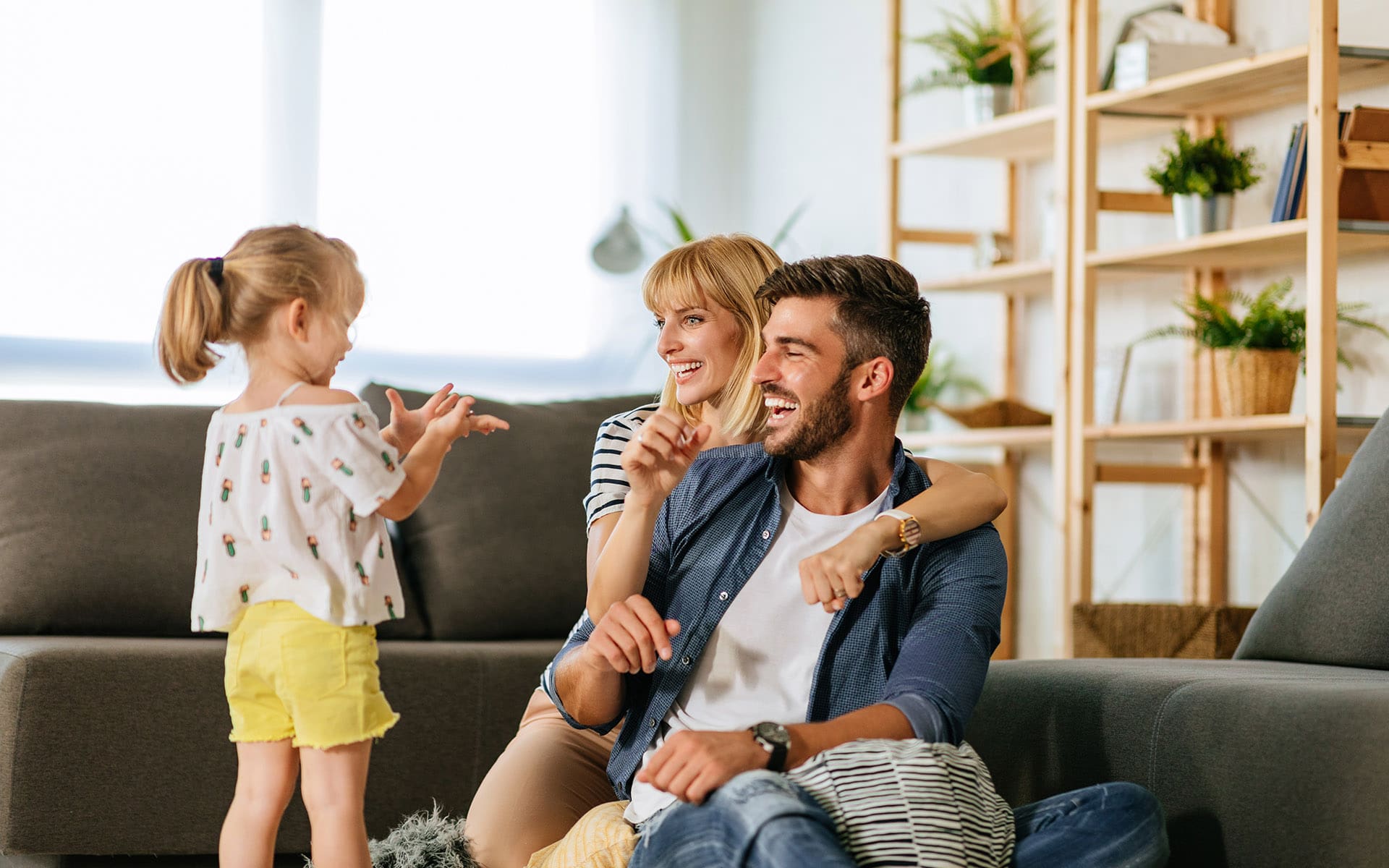 Homepage - Family and Daughter Laughing Together in Their Home